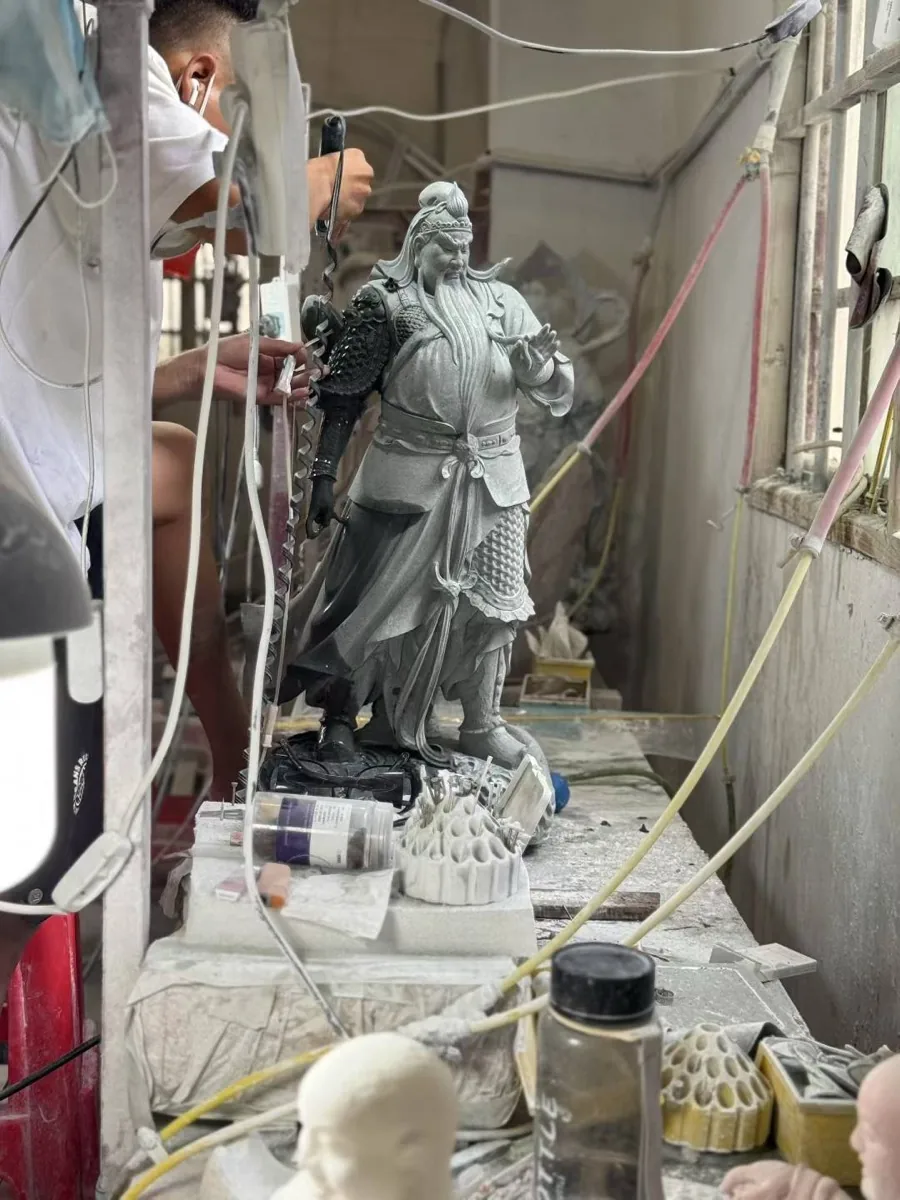 Clay maquette of a portrait head being prepared in the carving workshop