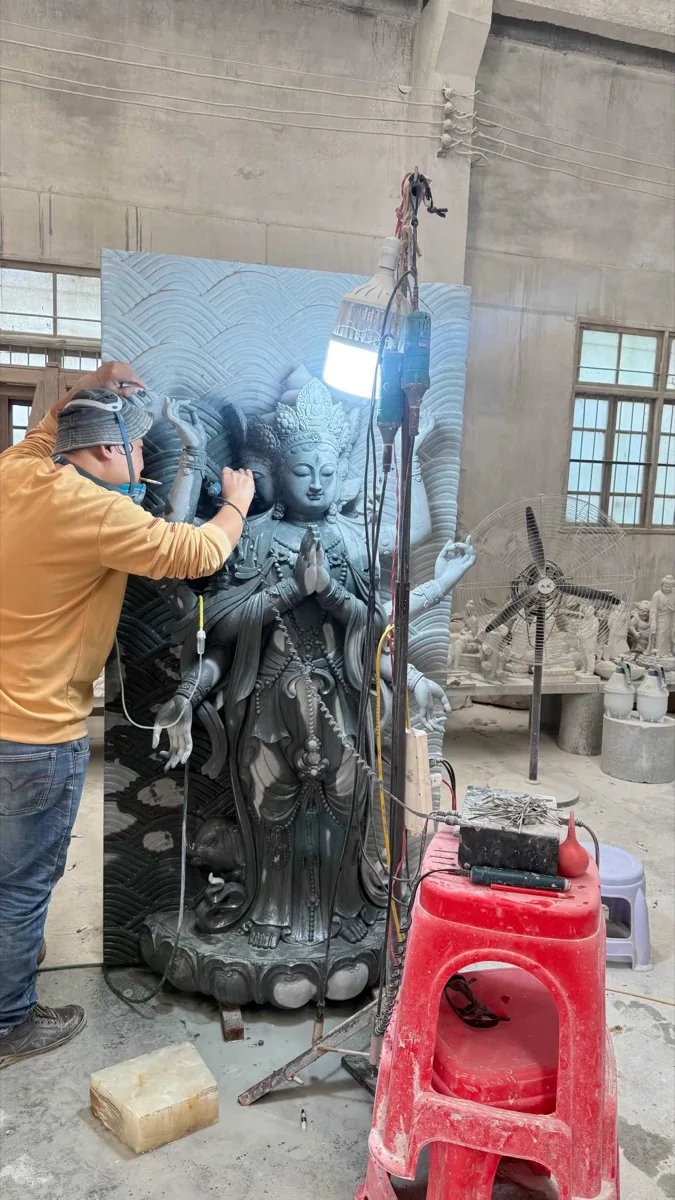 Large carved stone relief panel in the workshop yard